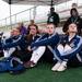 Members of the girls varsity team watch their game against  Huron under a tent.
Courtney Sacco I AnnArbor.com